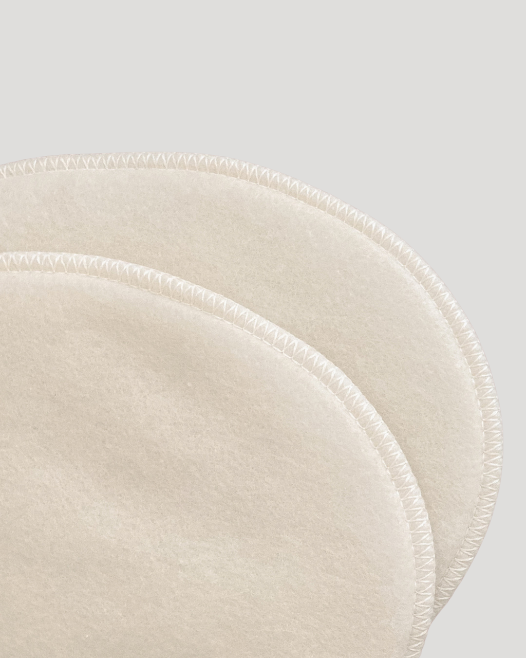 Close-up of beige circular placemats on a light gray background