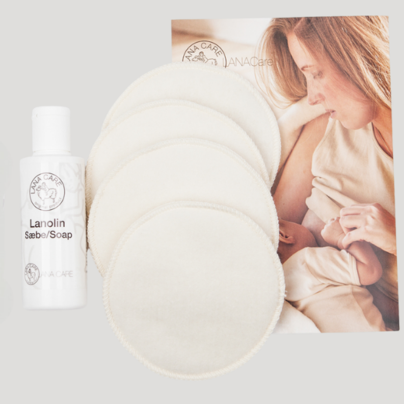 Lanolin Soap bottle with a woman holding a baby in the background