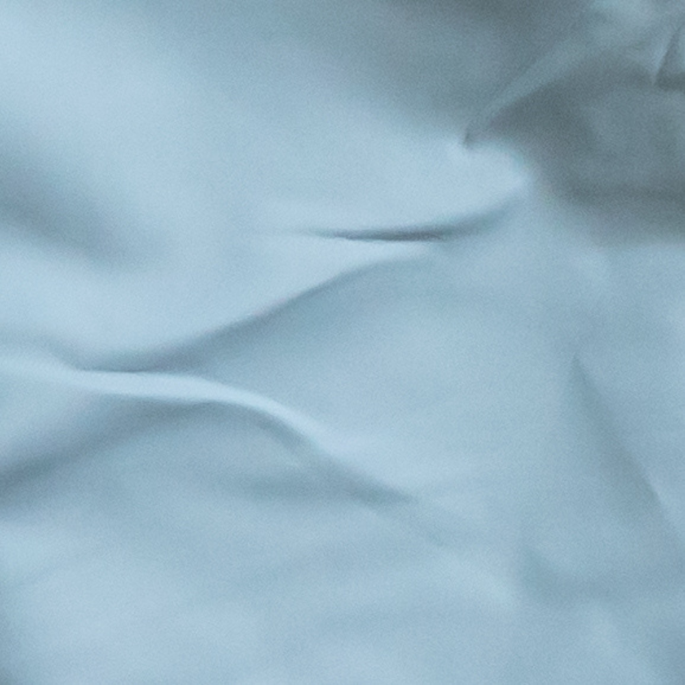 Close-up of light blue fabric with folds