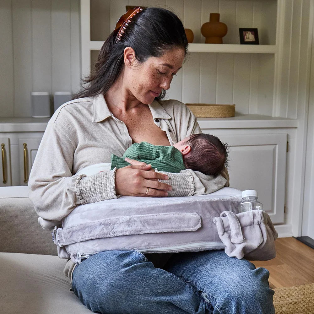 Woman breastfeeding a baby in a home setting
